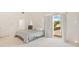 Bright bedroom with a queen-sized bed and access to a private balcony at 6515 Mauna Loa Blvd, Sarasota, FL 34241