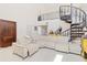 Spacious living room with a large sectional sofa and a spiral staircase at 6515 Mauna Loa Blvd, Sarasota, FL 34241