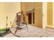 Inviting patio with wrought iron swing and brick pavers at 6515 Mauna Loa Blvd, Sarasota, FL 34241