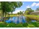 Serene pond with fountain feature in the community at 5412 11Th Street E Cir # 41, Bradenton, FL 34203