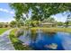 Peaceful pond with walkway and fountain in community at 5412 11Th Street E Cir # 41, Bradenton, FL 34203