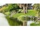Picturesque waterfront property showcasing lush greenery and birds at 18875 Ashcroft Cir, Port Charlotte, FL 33948