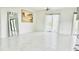 Open living room with large windows, tile floors, and modern art at 18875 Ashcroft Cir, Port Charlotte, FL 33948