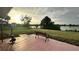 Relaxing patio overlooking a tranquil lake, perfect for enjoying sunsets at 18875 Ashcroft Cir, Port Charlotte, FL 33948