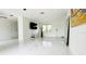 Bright living room with white tile floors and ceiling fan at 18875 Ashcroft Cir, Port Charlotte, FL 33948