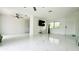 Spacious living area featuring modern ceiling fans and tile flooring at 18875 Ashcroft Cir, Port Charlotte, FL 33948