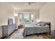 Bright bedroom with a ceiling fan, view from the window, and hardwood floors at 1003 Fairwaycove Ln # 205, Bradenton, FL 34212