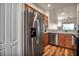 Kitchen featuring stainless steel appliances and wood cabinets, with view of living area at 1003 Fairwaycove Ln # 205, Bradenton, FL 34212