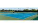 Well-maintained tennis courts with new netting and fencing, with a bench for players to rest at 1003 Fairwaycove Ln # 205, Bradenton, FL 34212