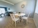 Dining area showcasing a round table with white chairs, wood floors, and a decorative wall piece at 2425 Flamingo Blvd # K28, Bradenton, FL 34207