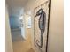 Hallway leading to dining area featuring a seahorse painting on the wall and hardwood floors at 2425 Flamingo Blvd # K28, Bradenton, FL 34207