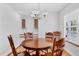 Dining area featuring hardwood floors, a chandelier, built-in cabinets and window views at 3125 Pickett St, Port Charlotte, FL 33981