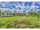 Expansive home featuring a covered patio and a large green lawn in a rural setting at 3125 Pickett St, Port Charlotte, FL 33981