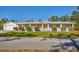 Charming single-story home featuring a columned front porch and a well-manicured lawn at 3125 Pickett St, Port Charlotte, FL 33981