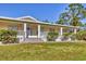 Charming one-story home with front porch and well-manicured lawn at 3125 Pickett St, Port Charlotte, FL 33981