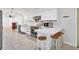 Well-lit kitchen featuring modern stainless steel appliances, ample counter space, and breakfast bar at 3125 Pickett St, Port Charlotte, FL 33981