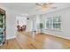 Bright living room with hardwood floors, large window with plantation blinds and ceiling fan at 3125 Pickett St, Port Charlotte, FL 33981