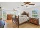 Spacious main bedroom features wood floors, ceiling fans, and natural light from double-hung windows at 3125 Pickett St, Port Charlotte, FL 33981