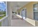 Inviting covered front porch with white columns offers a welcoming entrance at 3125 Pickett St, Port Charlotte, FL 33981