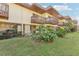 Rear view of townhouse with balcony and landscaping at 3339 Ramblewood Ct, Sarasota, FL 34237