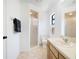 Bright bathroom has a glass shower, a neutral vanity with hardware, and decorative towels at 4175 Arrow Ln, Sarasota, FL 34232