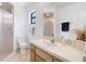 Bright bathroom featuring a walk-in shower, a spacious vanity with a mirror, and modern fixtures at 4175 Arrow Ln, Sarasota, FL 34232