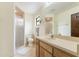 Bathroom with frosted glass shower, wooden vanity, and light countertops at 4175 Arrow Ln, Sarasota, FL 34232