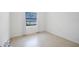 Empty bedroom with tiled floors, neutral walls, and natural light at 4175 Arrow Ln, Sarasota, FL 34232