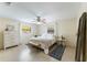 Comfortable bedroom boasts neutral walls, a ceiling fan, and plenty of natural light at 4175 Arrow Ln, Sarasota, FL 34232
