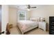 Bedroom with white wood bedframe, pink bedding, and natural decorations at 4175 Arrow Ln, Sarasota, FL 34232