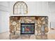 Close up of a stone fireplace with wooden mantle and hearth, creating a cozy living space at 4175 Arrow Ln, Sarasota, FL 34232
