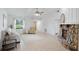 Spacious living room featuring a stone fireplace, large windows, and light tile flooring for a bright, open feel at 4175 Arrow Ln, Sarasota, FL 34232