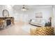 Bright living room featuring a stone fireplace, neutral furniture, tile flooring, and lots of natural light at 4175 Arrow Ln, Sarasota, FL 34232