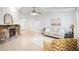 Bright living room featuring a stone fireplace, neutral furniture, tile flooring, and lots of natural light at 4175 Arrow Ln, Sarasota, FL 34232
