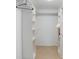 Organized walk-in closet with built-in shelving provides ample storage and easy access to wardrobe items at 4175 Arrow Ln, Sarasota, FL 34232