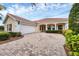 Charming single-story home features a tile roof, 2-car garage, and patterned paver driveway at 5901 Mariposa Ln, Sarasota, FL 34238
