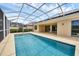 Large pool with a screened enclosure and attached patio at 5901 Mariposa Ln, Sarasota, FL 34238