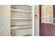 Open storage closet with three shelves at 3339 Ramblewood Ct, Sarasota, FL 34237