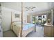 Bright bedroom with a large bed, dresser, and access to the patio at 213 Rubens Dr # D, Nokomis, FL 34275