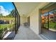 Screened porch with table and chairs at 213 Rubens Dr # D, Nokomis, FL 34275