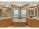 Elegant bathroom with double sinks, a large soaking tub, and a separate shower at 2151 Gulf Of Mexico Dr # 5, Longboat Key, FL 34228