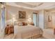 Bright bedroom with king-size bed and access to a private balcony at 2151 Gulf Of Mexico Dr # 5, Longboat Key, FL 34228
