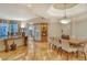 Spacious dining room with hardwood floors, large table and views to living room at 2151 Gulf Of Mexico Dr # 5, Longboat Key, FL 34228