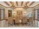 Grand dining room showcases a large table, exquisite chandelier, and warm color palette at 2151 Gulf Of Mexico Dr # 5, Longboat Key, FL 34228