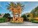 Grand entrance with palm trees and gated access at 2151 Gulf Of Mexico Dr # 5, Longboat Key, FL 34228