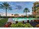 Tranquil pool area with palm trees, landscaping and building in background at sunset at 2151 Gulf Of Mexico Dr # 5, Longboat Key, FL 34228