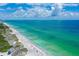 Aerial view of beachfront property with pristine beach and clear water at 2151 Gulf Of Mexico Dr # 5, Longboat Key, FL 34228