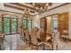 Formal dining room features a long wooden table, comfortable chairs, and access to patio at 2151 Gulf Of Mexico Dr # 5, Longboat Key, FL 34228