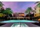 Luxury condo building at dusk, showcasing a lit-up unit and pool area at 2151 Gulf Of Mexico Dr # 5, Longboat Key, FL 34228