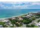 Aerial view showcasing condo building's beachfront location and lush landscaping at 2151 Gulf Of Mexico Dr # 5, Longboat Key, FL 34228
